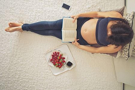 Pregnant woman reading a book